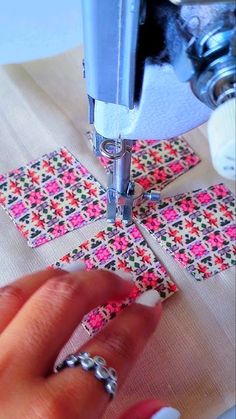 someone is using a sewing machine to sew fabric