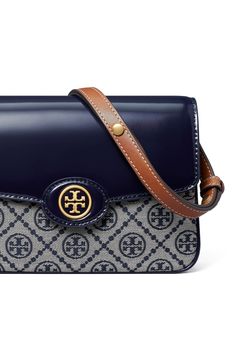 Gleaming hardware and signature logo jacquard distinguish a structured bag fashioned with an adjustable strap for a customized fit. Magnetic-snap flap closure Adjustable shoulder strap Interior wall pocket Structured silhouette with flat base for stability Lined Textile/leather Imported T Monogram, Tory Burch Robinson, Structured Bag, Tory Burch Bag, Interior Wall, Wall Pockets, Signature Logo, Convertible, Tory Burch