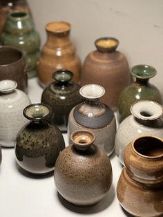 many different colored vases are lined up together