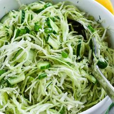 a white bowl filled with shredded green vegetables