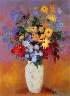 a vase filled with lots of colorful flowers