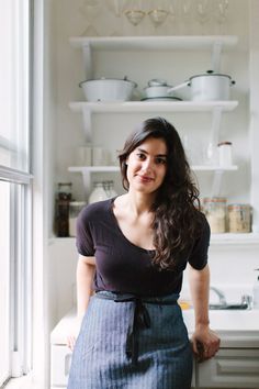 a woman standing in front of a refrigerator