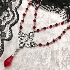 Dear customers, for a price offer of expedited shipping outside of Germany, please contact me directly via Etsy messages. Gothic and classy, Swarovski deep red beaded necklace with a detailed filigree pendant, made to star with your dress for a formal event or a with casual dress. - Handmade jewelry - Red high quality Swarovski bicone beads  - Red high quality Swarovski teardrops - Detailed metal filigree   Sizes: -Necklace Length: Approximately 35 cm -Extension: Approximately 5 cm ❤️ All of the Black And Red Necklace, Rhodolite Garnet Jewelry, Smoky Makeup, Red Beaded Necklace, Elegant Wardrobe, Red Beaded Necklaces, Necklace Gothic, Diy Jewelry Projects, Gothic Gifts