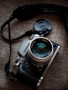 a camera sitting on top of a brown cloth