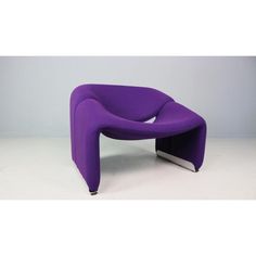 a purple chair sitting on top of a white floor