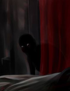 a black cat peeks out from behind the curtains in a dark room with red drapes