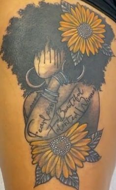 the back of a woman's thigh with sunflowers