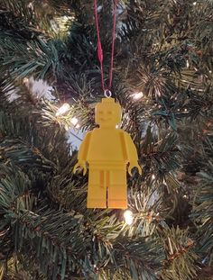 a lego man ornament hanging from a christmas tree