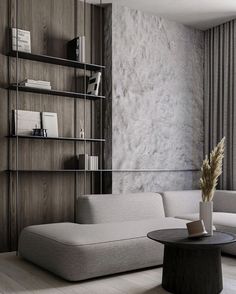 a living room filled with furniture next to a tall book shelf on the side of a wall