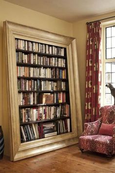 a living room filled with furniture and a large book case in front of a window