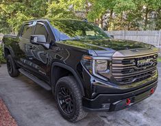 a black truck is parked in the driveway