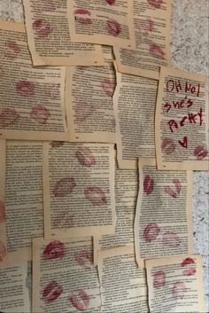 several pieces of paper with red lipstick imprints on them