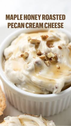 a white plate topped with food next to crackers and a bowl filled with cream cheese