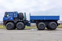 a large blue truck parked on top of a parking lot