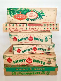 five boxes stacked on top of each other with christmas decorations and ornaments in them, all labeled shiny brite