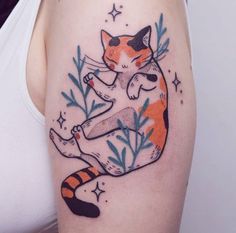 a woman with a cat tattoo on her arm