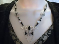 "This beautiful necklace has a black faceted glass setting on a sterling silver plated filigree pendant, a pewter silver pentacle, czech glass beads, seed beads, pewter silver bead caps, pewter silver filigree accents, black crystal drops and metal chain. 18\" long. Toggle clasp." Gothic Silver Necklaces For Festival, Silver Metal Witchy Jewelry, Nickel Free Gothic Pendant Jewelry, Witchy Silver Metal Jewelry, Silver Witchy Metal Jewelry, Gothic Nickel-free Pendant Jewelry, Nickel-free Gothic Pendant Jewelry, Mystical Nickel-free Black Jewelry, Mystical Black Nickel-free Jewelry