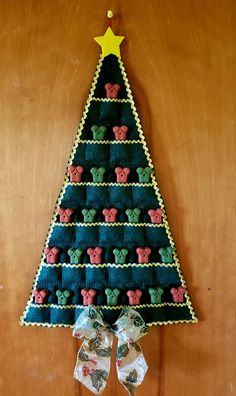 a christmas tree made out of cookies on top of a wooden table next to a bow