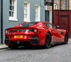 a red sports car is parked on the street