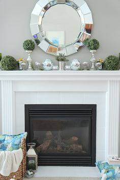 a living room with a fire place and mirror on the wall above it's mantle