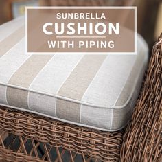 the sunbrella cushion with piping is sitting on top of a wicker chair