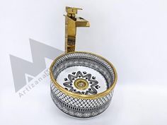 a white and gold sink sitting on top of a counter