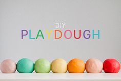 colorful playdoughs lined up in a row with the words diy playdough