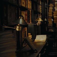 an old library with bookshelves, lamps and a book on the table in front of it