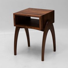 a small wooden table with an open drawer on the bottom and one shelf below it