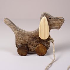 a wooden toy dachshund dog on a white background