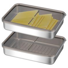 two metal trays with cheese slices in them