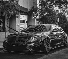 a black car parked in front of a parking meter