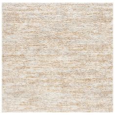 an area rug with light brown and white colors on the floor, it looks like wool