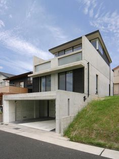 a modern house on the side of a hill