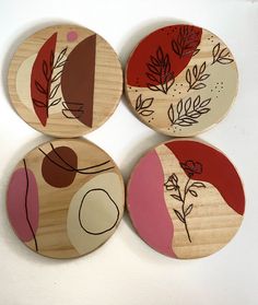 four wooden plates with different designs on them