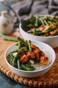 two bowls filled with rice and green beans