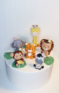 a white cake topped with animals on top of it