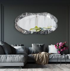 a living room filled with furniture and a large round mirror on the wall above it