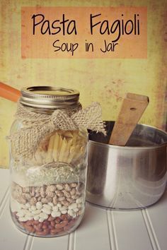 a jar filled with food sitting on top of a white table next to a metal pan