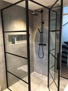 a walk in shower sitting inside of a bathroom