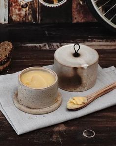 there is a cup and saucer sitting on the table next to some slices of bread