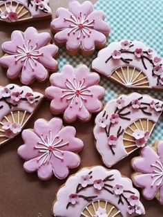 decorated cookies with pink icing on a table