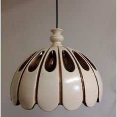 a white and brown lamp hanging from a ceiling