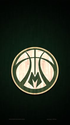 a basketball logo on the side of a green wall