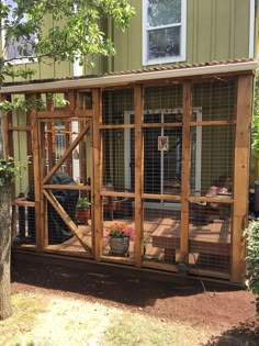 a wooden structure with metal bars on the sides and doors open to let in natural light