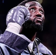 a close up of a person wearing boxing gloves