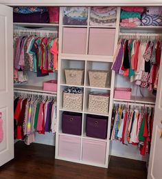 an organized closet with pink and purple bins, white cubby drawers, and lots of clothes