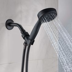 the shower head is open and running with water coming from it's spout