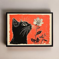 a black cat is looking up at a flower on an orange and red background with white flowers in the foreground