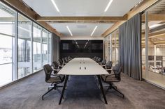 an empty conference room with glass walls and sliding doors leading to the meeting room area